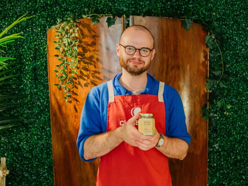 A man holds a handmade candle he made at candle making class he was gifted